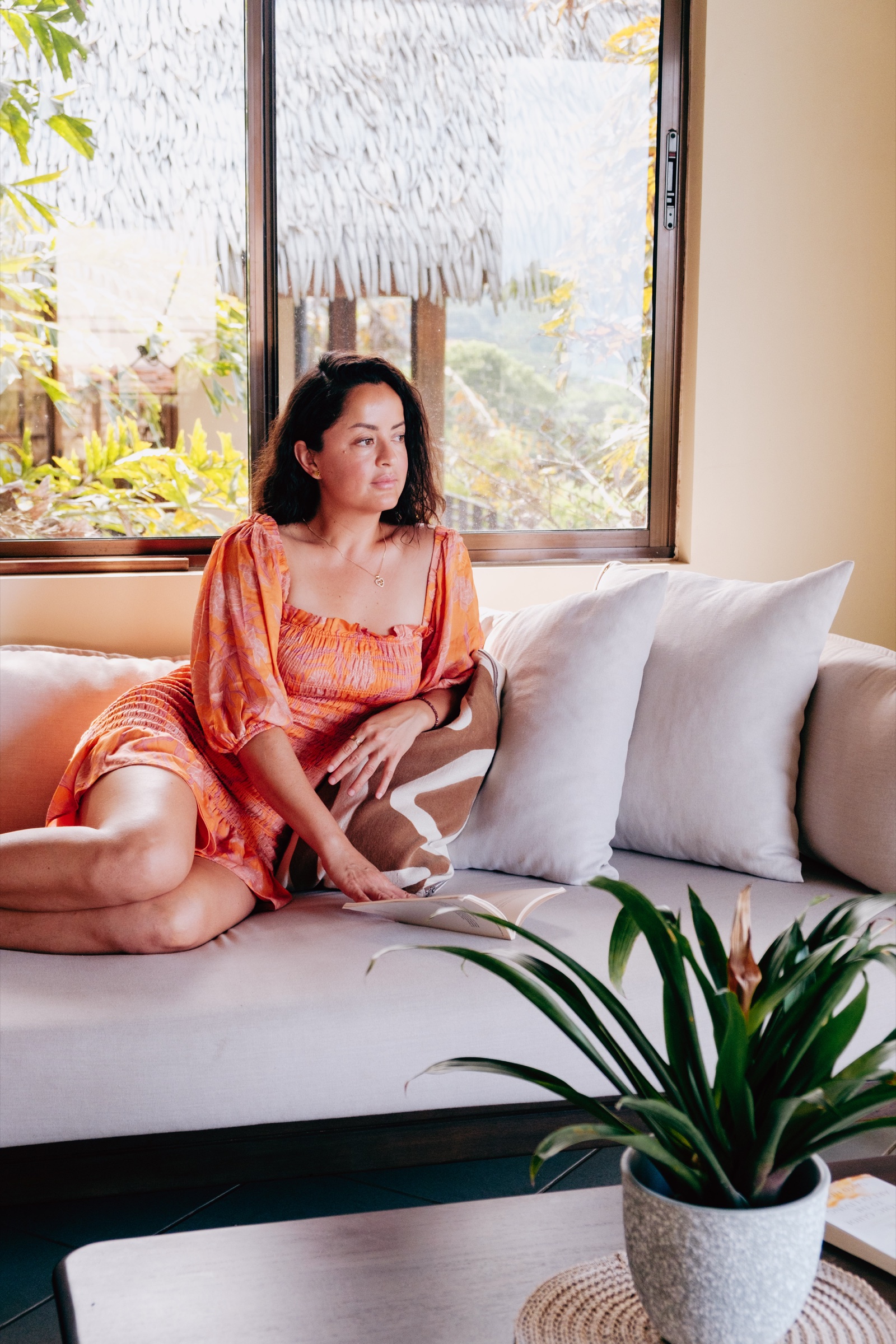 A guest unwinding with a book in Casa Calma's light-filled lounge